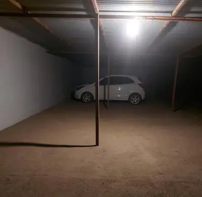 a white car parked in a parking garage at Hosteria Rivadavia in Mina Clavero