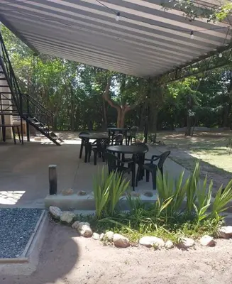 a group of tables and chairs under a canopy at Hosteria Rivadavia in Mina Clavero