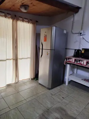 a refrigerator in the corner of a kitchen at Ohana in Potrero de Garay