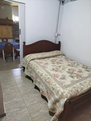 a bed with a quilt on it in a bedroom at Ohana in Potrero de Garay