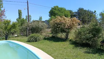 a view of a yard with a house and trees at Ohana in Potrero de Garay