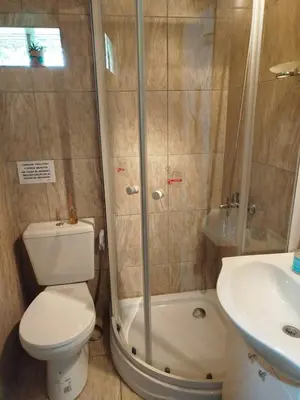 a bathroom with a shower and a toilet and a sink at Ohana in Potrero de Garay