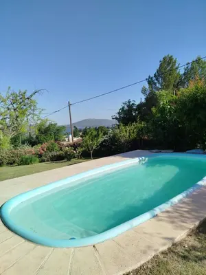 a large blue swimming pool in a yard at Ohana in Potrero de Garay