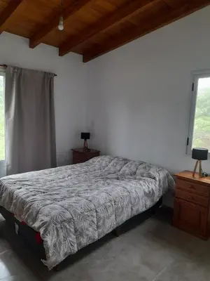 a bedroom with a bed and a window at Casa los nonos in Cavalango