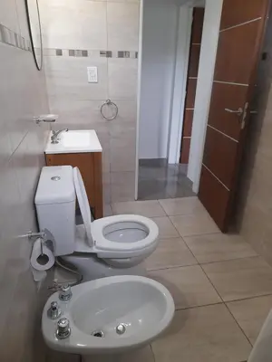 a bathroom with a toilet and a sink at Casa los nonos in Cavalango