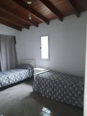a room with two beds and a window at Casa los nonos in Cavalango