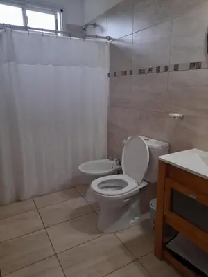 a bathroom with a toilet and a sink at Casa los nonos in Cavalango