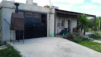 a house with a large black door in front of it at Monoambiente in Villa Parque Siquiman