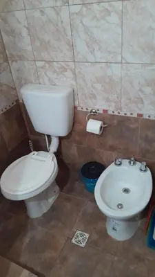 a bathroom with a toilet and a sink at Monoambiente in Villa Parque Siquiman