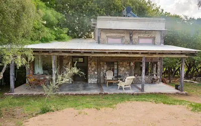 an old house with a porch and a table and chairs at Don Federico in San Javier