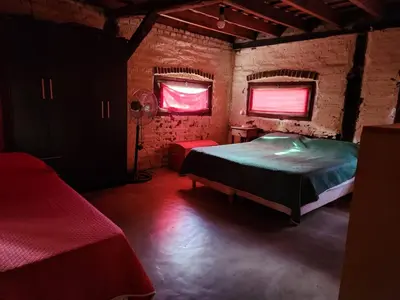 a bedroom with a bed and a fan and two windows at Don Federico in San Javier