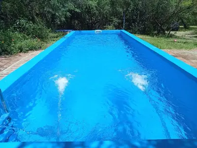 a pool of blue water with two people in it at Don Federico in San Javier
