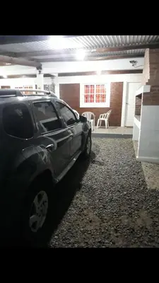 a black car parked in front of a building at Postal Serrana 2 in Villa Cura Brochero