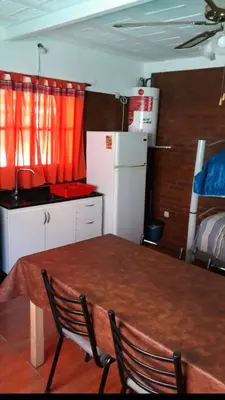 a kitchen with a table and chairs in a room at Postal Serrana 2 in Villa Cura Brochero