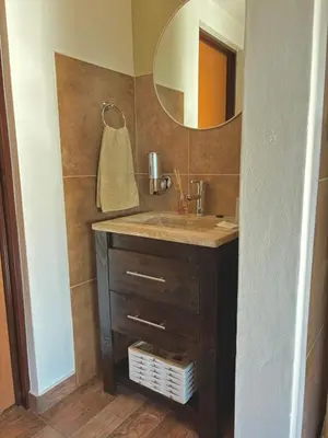 a bathroom with a sink and a mirror at Green Valley Retreat in Villa General Belgrano