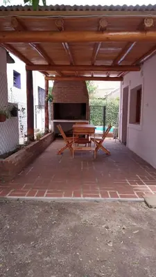 a patio with a picnic table under a wooden pergola at casitadearminda-II in Villa de Las Rosas