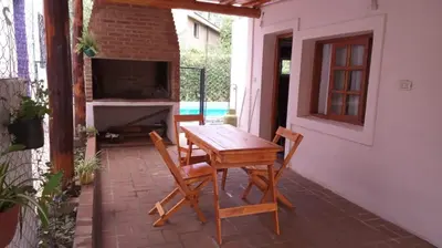 a wooden table and chairs on a patio at casitadearminda-II in Villa de Las Rosas