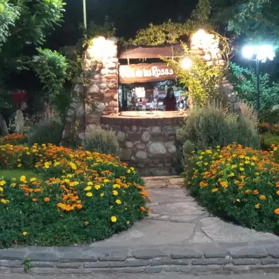 a flower garden in front of a flower shop at night at casitadearminda-II in Villa de Las Rosas