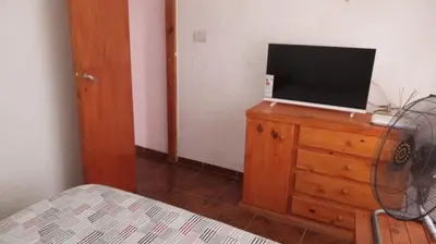 a bedroom with a bed and a television on a dresser at casitadearminda-II in Villa de Las Rosas