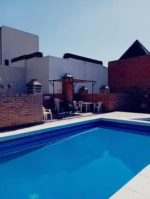 a swimming pool on the roof of a building at Villa Carlos Paz Inn in Villa Carlos Paz