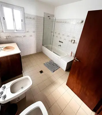 a bathroom with a sink and a shower and a toilet at Villa Carlos Paz Inn in Villa Carlos Paz