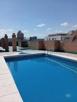 a swimming pool on the roof of a building at Villa Carlos Paz Inn in Villa Carlos Paz