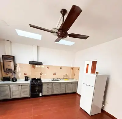 a kitchen with a ceiling fan and a refrigerator at Villa Carlos Paz Inn in Villa Carlos Paz