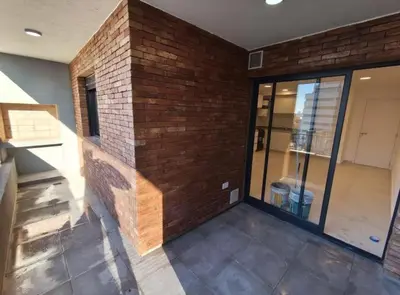 an empty room with a brick wall and a door at Villa Carlos Paz Inn in Villa Carlos Paz