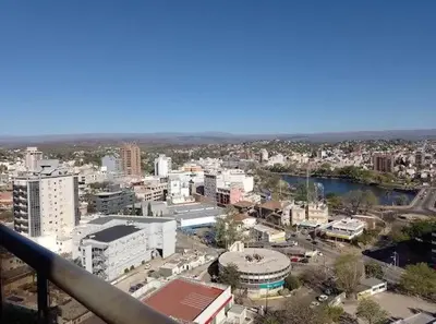 a view of a city with buildings and a river at Villa Carlos Paz Inn in Villa Carlos Paz