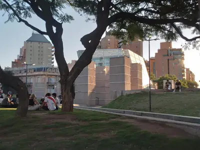 a group of people sitting on the grass in a park at Departamento Plaza España in Cordoba