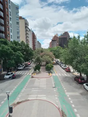an empty street in a city with trees and cars at Departamento Plaza España in Cordoba