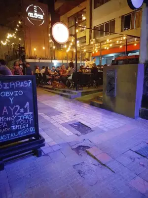 a restaurant with a sign in the middle of a sidewalk at Departamento Plaza España in Cordoba