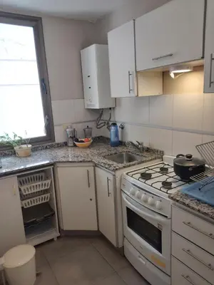 a kitchen with a stove and a sink at Departamento Plaza España in Cordoba