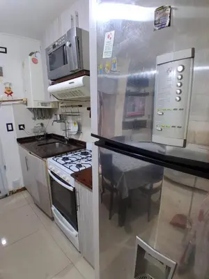 a kitchen with a sink and a stove top oven at beautiful apartment, two blocks from the pedestrian street in Villa Carlos Paz