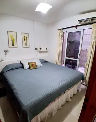 a bedroom with a large bed and a window at beautiful apartment, two blocks from the pedestrian street in Villa Carlos Paz