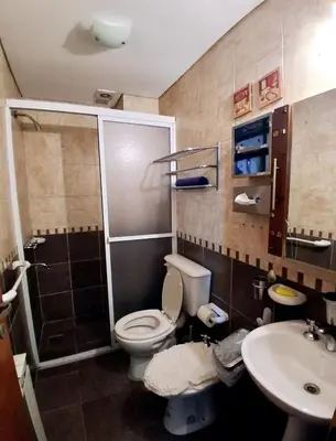 a bathroom with a toilet and a sink at beautiful apartment, two blocks from the pedestrian street in Villa Carlos Paz