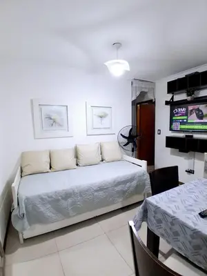 a living room with a bed and a dining table at beautiful apartment, two blocks from the pedestrian street in Villa Carlos Paz
