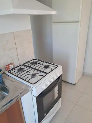 a stove top oven in a kitchen next to a sink at Departamento Alta Gracia in Alta Gracia