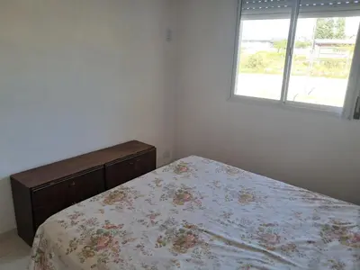 a bedroom with a bed and a window at Departamento Alta Gracia in Alta Gracia