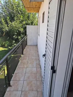 a balcony with a door and a walkway at Departamento Alta Gracia in Alta Gracia