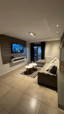 a living room with a couch and a table at Departamento centro Rio Cuarto con Cochera in Río Cuarto