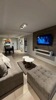 a living room with a couch and a table and a tv at Departamento centro Rio Cuarto con Cochera in Río Cuarto