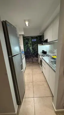 a kitchen with a stainless steel refrigerator and counters at Departamento centro Rio Cuarto con Cochera in Río Cuarto