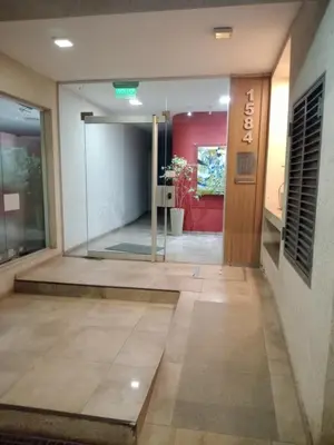 a lobby with a glass door in a building at Departamento en Gral paz in Cordoba