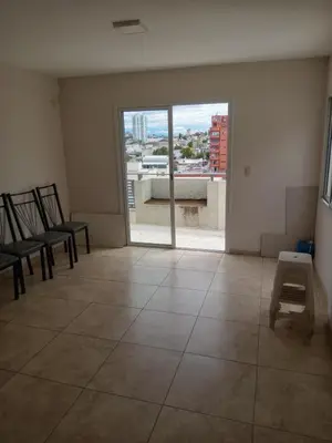 an empty room with chairs and a large window at Departamento en Gral paz in Cordoba