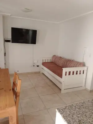 a room with a bed and a tv on a wall at Departamento en Gral paz in Cordoba