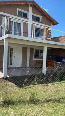 a house with a fence in front of it at Casa para 5 personas a 1 cuadra del río los Reartes in Villa Ciudad Parque