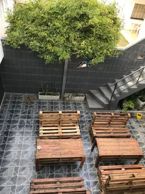 a group of wooden benches sitting on a patio at Faro del Parque in Cordoba