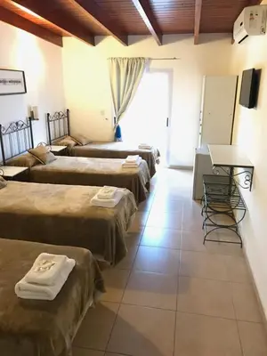a group of four beds in a room at Faro del Parque in Cordoba