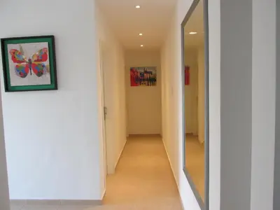 a hallway with a mirror on the wall at Faro del Parque in Cordoba